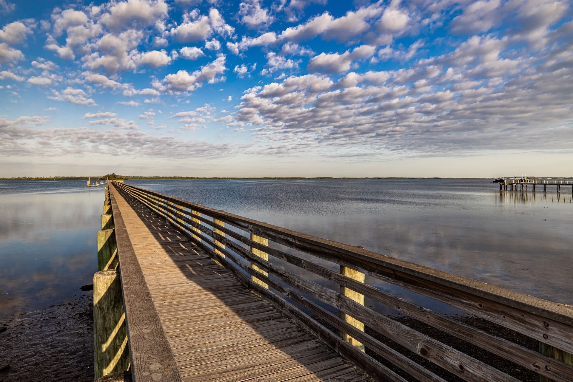 Long wooden pier over calm water